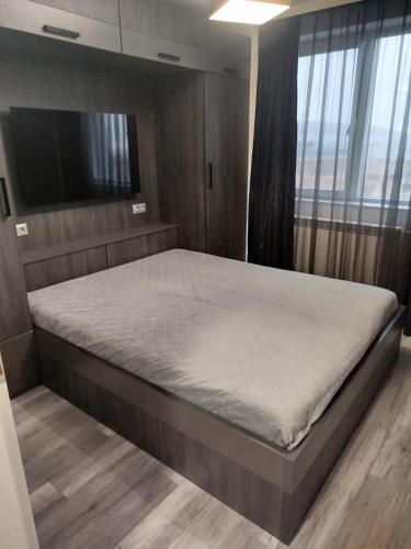 a bedroom with a large bed in a room at Apartment Diva in Shumen
