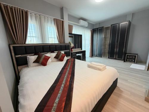 a bedroom with a large bed in a room at Home Hug You in Chiang Mai
