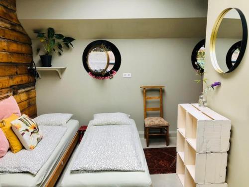 a living room with two beds and a mirror at Houseboat Tante Piet in Amsterdam