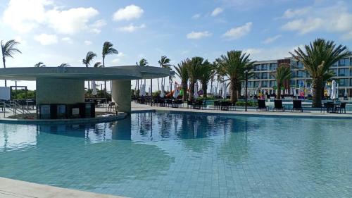 Apart-Resort Porto 2 Life في إيبوجوكا: مسبح في منتجع فيه نخل ومبنى