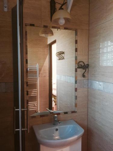 a bathroom with a sink and a mirror at Agroturystyka Catranch in Grębków