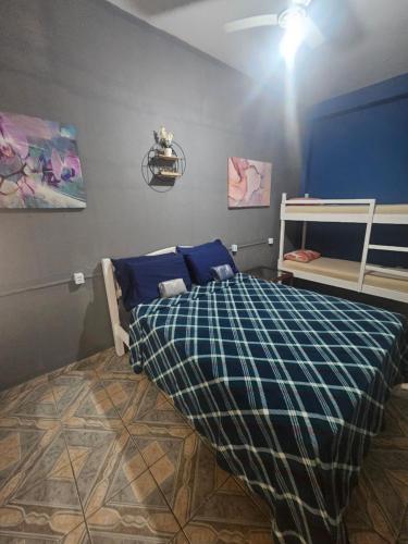 a bedroom with a bed and a bunk bed at Hope Hostel Praia do Morro in Guarapari