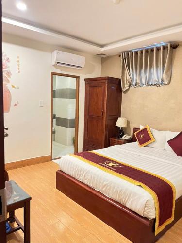a bedroom with a large bed and a window at Golf Star Hotel in Ho Chi Minh City