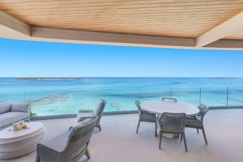 a dining room with a view of the ocean at Beachfront 3 bedroom Luxury Residence in Nassau