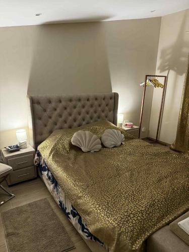 a bedroom with a bed with two pillows on it at Spa Sola in Mecquignies