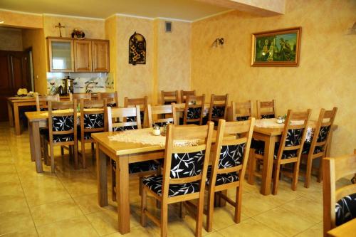 a dining room with wooden tables and chairs at Biesiada in Czarna Góra