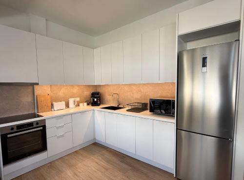 Kuchyň nebo kuchyňský kout v ubytování SitiaHeights Apartment