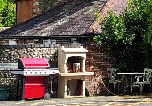 a brick building with a stove and a grill at Escape the Ordinary in Piddletrenthide