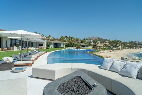 a living room with couches and a swimming pool at Casa Elije in San José del Cabo