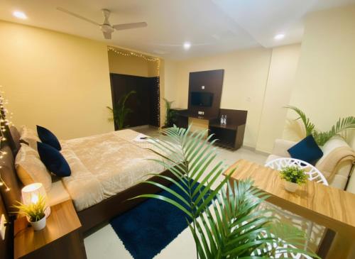 a bedroom with a bed and a living room at Hotel Velvet Stay Near DLF Cyber City in Hyderabad