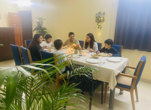 a group of people sitting around a table at Hotel Velvet Stay Near DLF Cyber City in Hyderabad