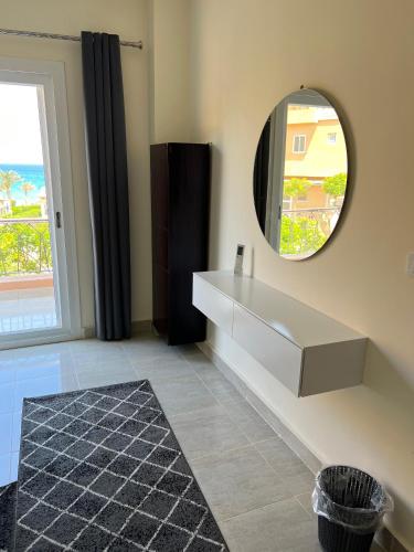 a bathroom with a sink and a mirror at Private Villa Sea View 5BR in Ain Sokhna