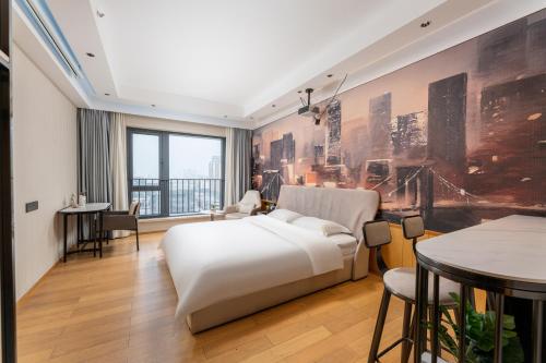 a bedroom with a white bed and a large window at Yizhimei Apartment Hotel-Guangzhou Huijin International Financial Center Keyun Road Subway STN Branch in Guangzhou