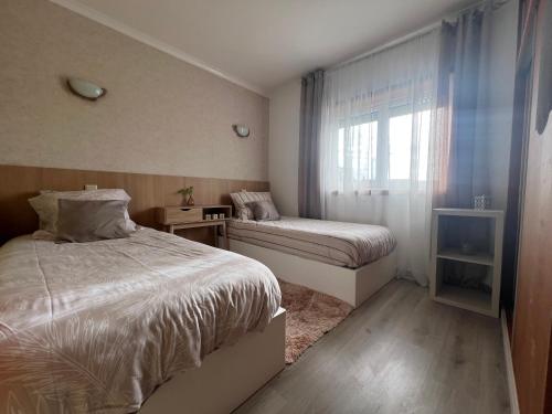 a small bedroom with a bed and a window at Grace House in Belinho