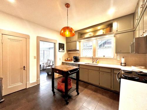 a kitchen with a table in the middle of it at Derby and Downtown in Louisville