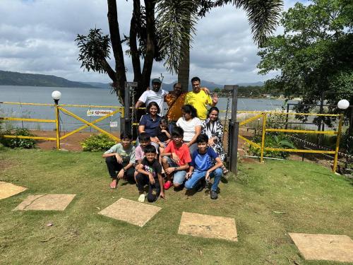 Pawna Tent Camp by Maitri Pawna Lake في Kolvan: مجموعة من الناس يتظاهرون للحصول على صورة