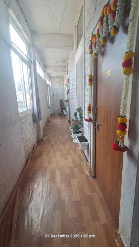 an empty hallway of an office with a wooden door at Sitaram Atithi Grha in Godarpura