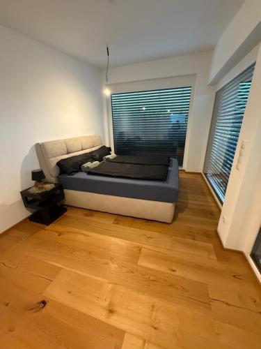 a bed in a room with a large window at Bennett Apartment in Vienna