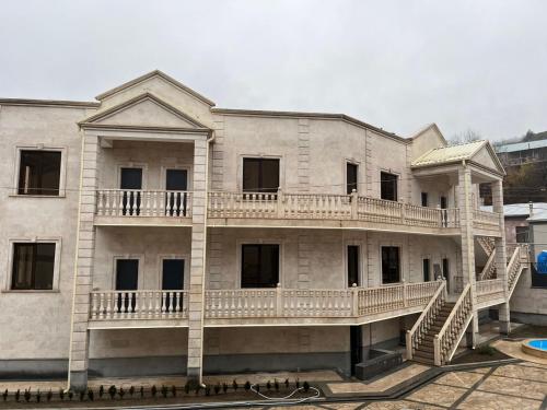an old building with a balcony on the side of it at Harutyunyants Hall in Ijevan