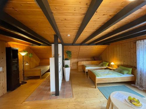 a bedroom with two beds in a room with wooden ceilings at Bunnyhill in Elchingen