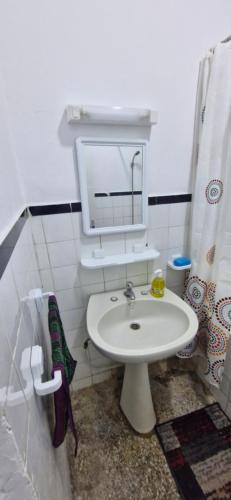 a bathroom with a white sink and a mirror at Appartement Océan in Rabat