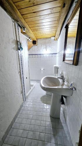 a bathroom with a sink and a mirror at B&B Montiju in Ozieri
