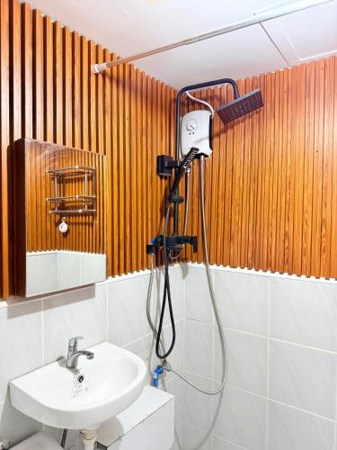 a shower in a bathroom with a sink and a mirror at saekyung marigondon 1 in Lapu Lapu City