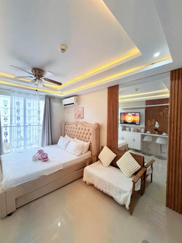 a bedroom with a bed and a couch and a tv at saekyung marigondon 1 in Lapu Lapu City