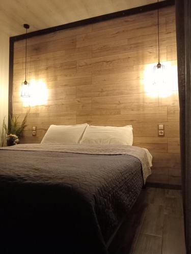 a bedroom with a large bed with two lights on it at Vorzel house in Vorzel