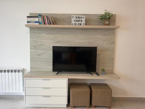a living room with a flat screen tv on a wall at Carpe Diem Monte Hermoso in Monte Hermoso