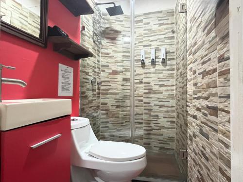 een badkamer met een toilet en een douche bij La Puerta Blanca #5 in Puerto Vallarta