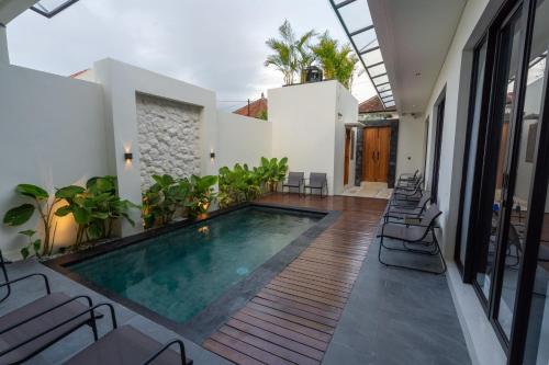 a swimming pool in the middle of a house at Maharani Villa & Guesthouse Uluwatu in Uluwatu