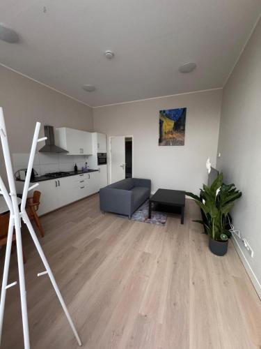 a living room with a couch and a kitchen at Getferweg 50-2 City Appartement in Enschede