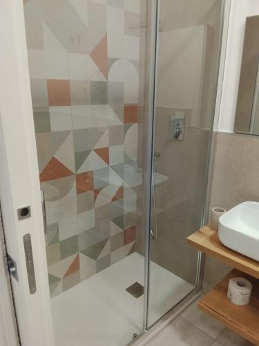 a shower with a glass door in a bathroom at Regia Dimora in Eboli