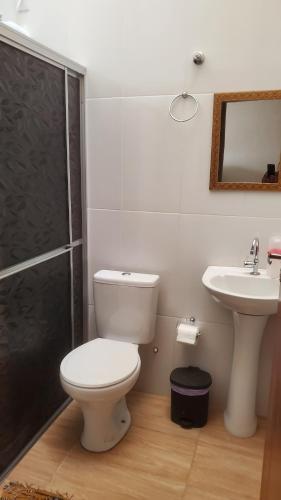 a bathroom with a toilet and a sink at Pelourinho in Olímpia