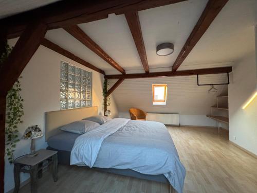 a bedroom with a large bed in a room at Résidence du Loeb in Eschau