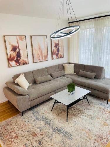 a living room with a couch and a table at Dinka Apartments Park Lake in Tuzla