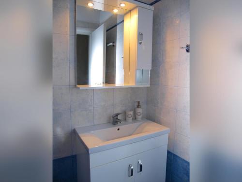 a bathroom with a sink and a mirror at Melograno Apartments and Studios in Kala Nera