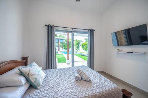 Una cama con un par de chanclas. en Casa Alegria, en Jacó