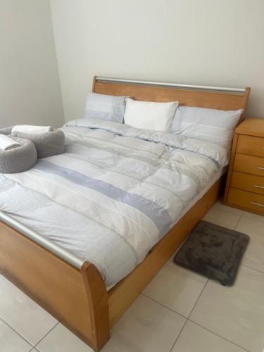 a large bed with a wooden frame in a room at By the Sea in Swakopmund