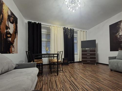 a living room with a couch and a table at Apartament Antracyt in Wałbrzych