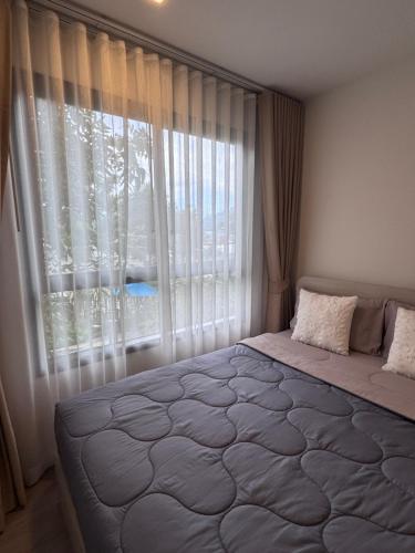 Ένα ή περισσότερα κρεβάτια σε δωμάτιο στο DCondo Kathu ใกล้หาดป่าตอง