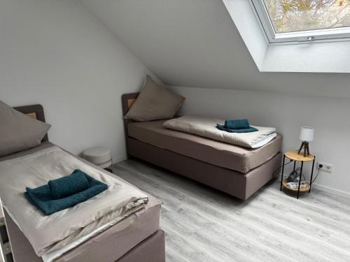 a attic room with two beds and a couch at Ferienhaus Moritz in Ippesheim