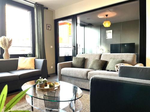 a living room with two couches and a glass table at La Loggia - Appartement Terrasse Esch Belval in Esch-sur-Alzette