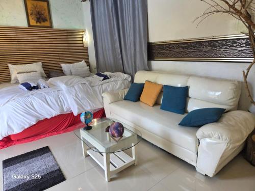 a living room with two beds and a couch at Fehivilla Residence in Dhangethi