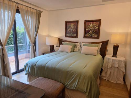a bedroom with a large bed and a window at Casa dos sonhos em Vale do Lobo in Loulé