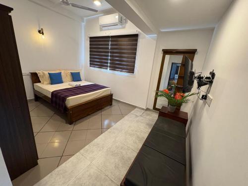 a bedroom with a bed and a television in it at Villa DEE DEE & Wellness in Galle