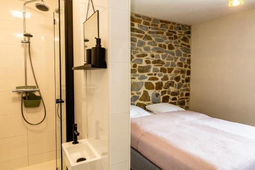 a bathroom with a bed and a shower with a sink at Villa Basse Cour in Durbuy