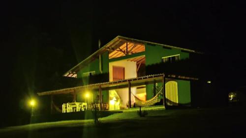 een groen en wit gebouw 's nachts bij Sitio e Pousada Vagalumes in Engenheiro Passos
