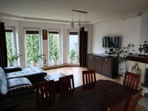 a living room with a table and a couch at Agroturystyka na Winnicy in Dys